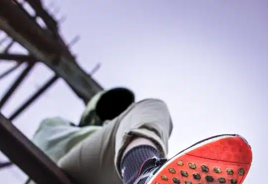 Man Sitting on Tower Base