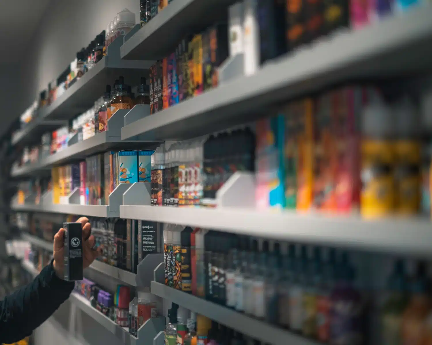 woman in black shirt standing in front of store shelf