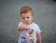 a baby with his finger in his mouth