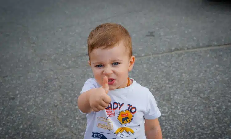 a baby with his finger in his mouth